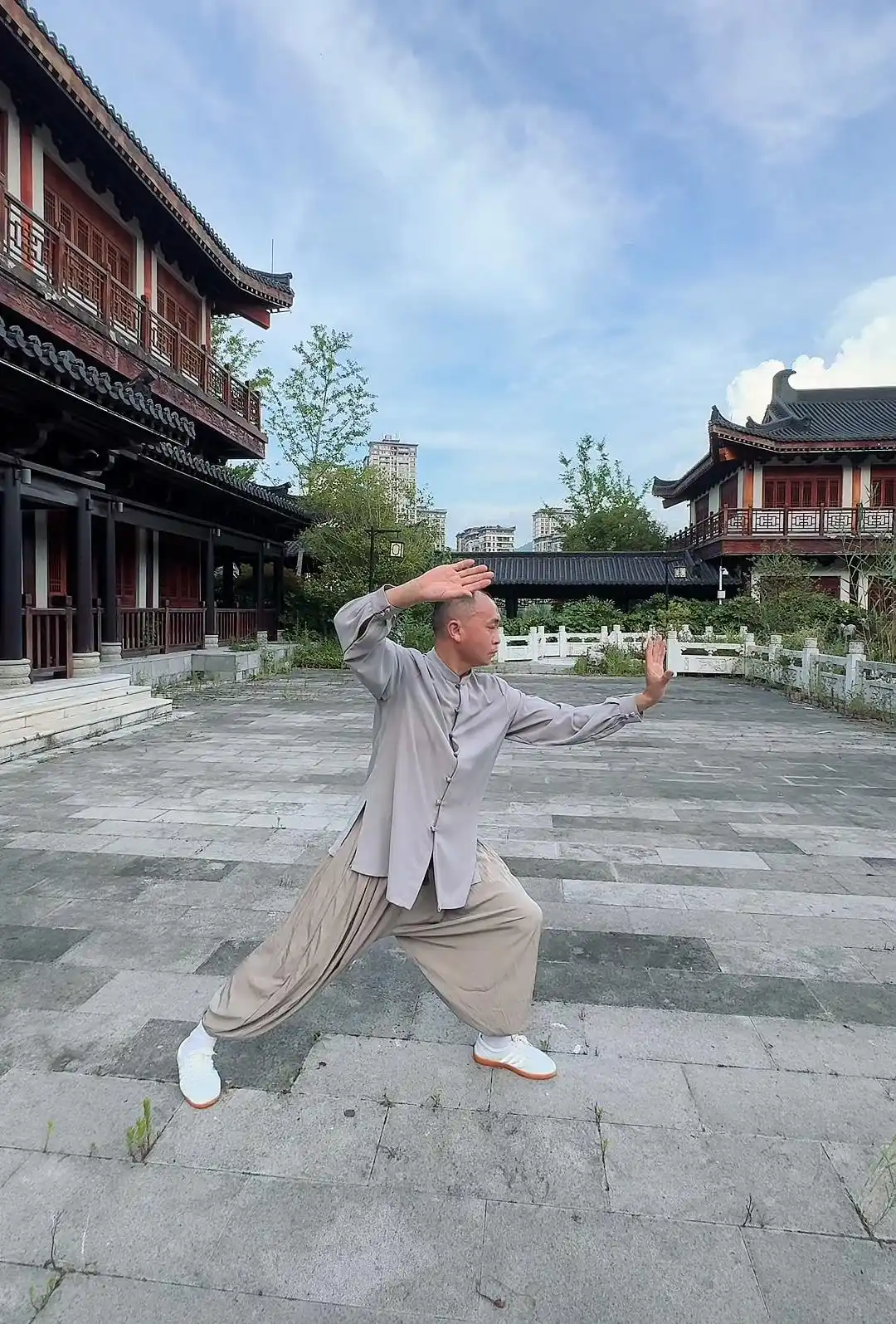 Man practicing Tai Chi walking in park for weight loss, demonstrating low stance